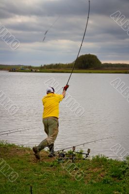 fisher with rod near the river