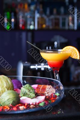 Orange cocktail with a straw