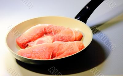 the meat in frying pans