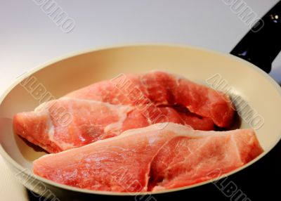 the meat in frying pans