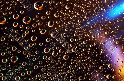 Water drops over colored background 