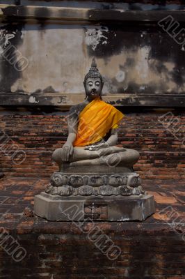 Buddha statue holding a plumeria flowers