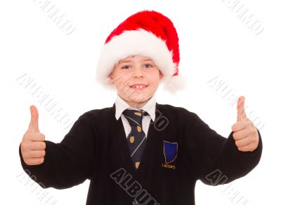 Happy smiling school boy in Santa hat.