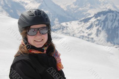 Young woman in ski clothes - mountains in the background