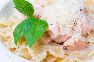 a plate of pasta decorated with basil