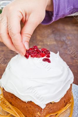 Hands decorating christmas cake