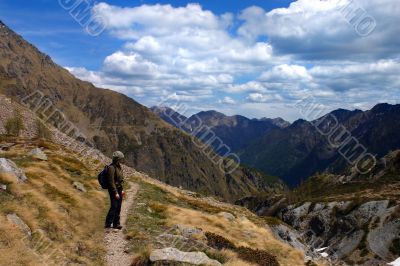 Girl hiking and mountain landscape