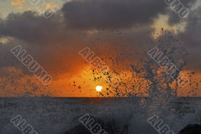 Splashes of high waves obscure the sun Splashes of high waves obscure the sun
