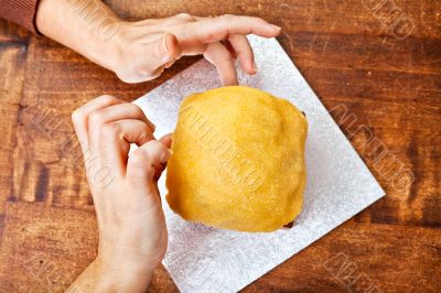 Hands decorating christmas cake from above