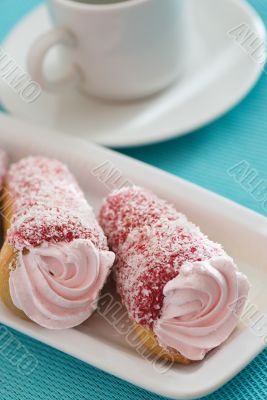 Two cakes with pink cream on a blue background