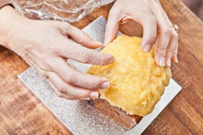 Hands modeling cake icing