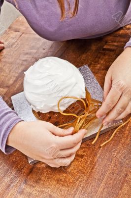 Woman decorating christmas cake