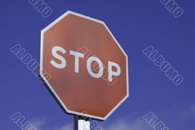 Stop Sign close up on blue sky
