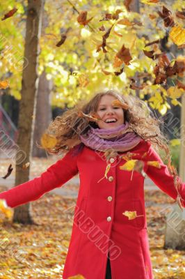 Young woman with autumn leaves