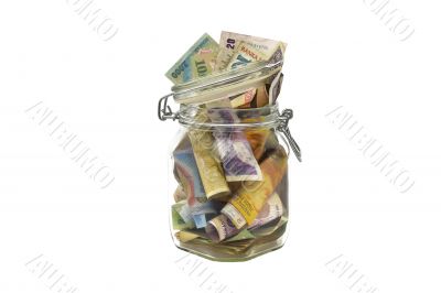 Old banknotes in a glass jar