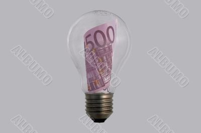 The concepts of money and energy are encased in a light bulb