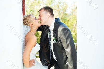 Bride and groom posing on a white background