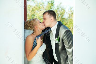 Bride and groom posing on a white background