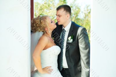 Bride and groom posing on a white background