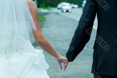 Walk with fingers joined the bride and groom