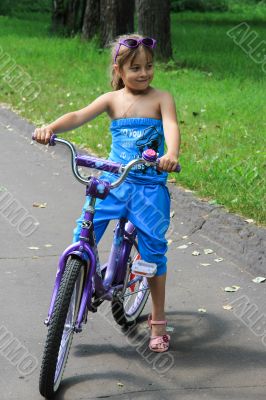 6 years old girl riding a bicycle.