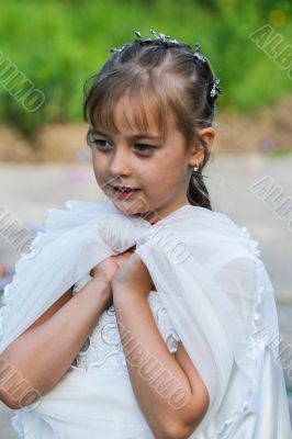 Elegant girl 7 years standing on the street.