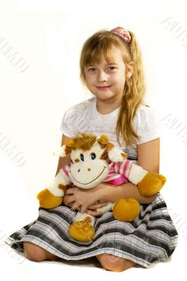 Beautiful little girl playing with a bear.