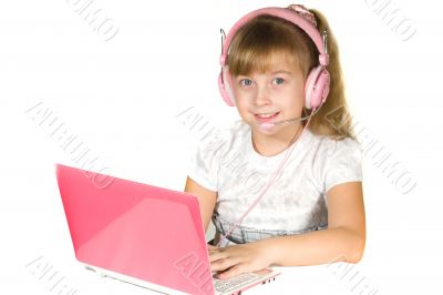 Beautiful little girl with headphones and a computer