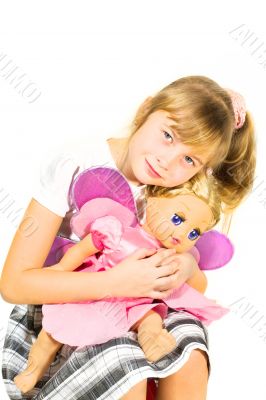 Beautiful little girl playing with a doll.
