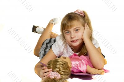 Beautiful little girl playing with a doll.