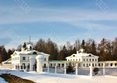 White old time buildings on the background of trees