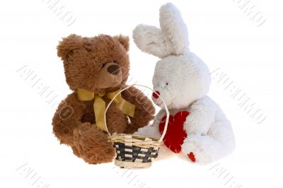 Toy teddy bear and a rabbit with a basket.