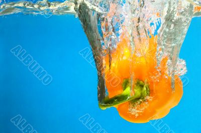YELLOW PEPPER SPLASHING IN WATER 