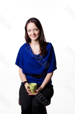 The young charming girl with a tea cup