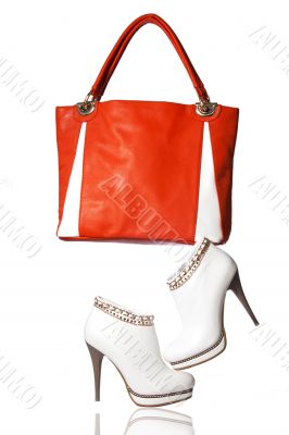 A pair of women`s ankle boots and handbag