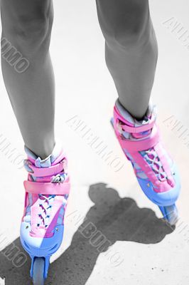 slender tanned women`s legs in roller skates