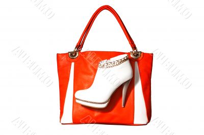A pair of women`s ankle boots and handbag