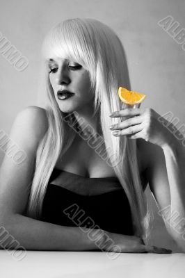 Beautiful blonde in a bar drinking tequila