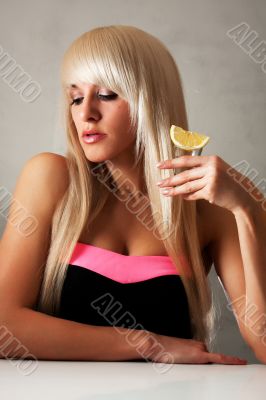 Beautiful blonde in a bar drinking tequila