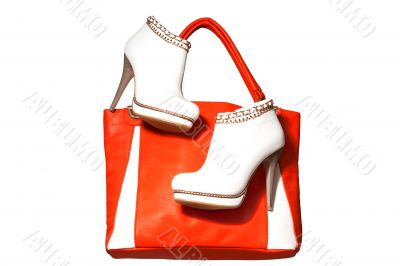A pair of women`s ankle boots and handbag