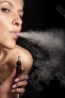 Woman smokes a hookah