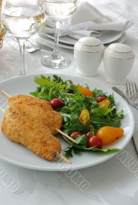 Chicken schnitzel garnish of arugula and tomatoes