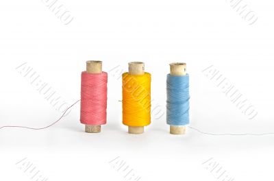 Three colorful spools of thread 