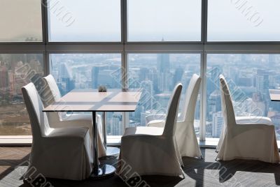 empty desk in a skyscraper restaurant