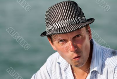 portrait of a man in a hat amazed