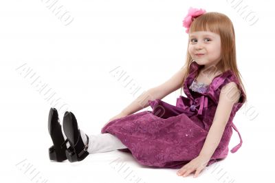Four-year girl sitting on white floor