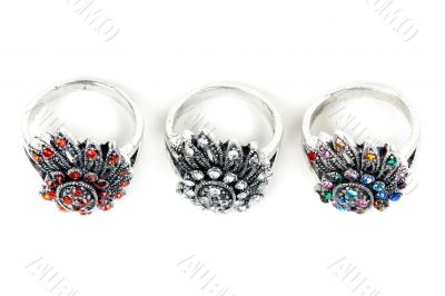 Three silver rings with precious stones