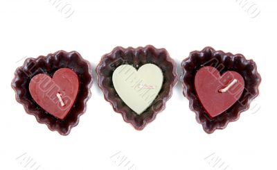three candles in the shape of a heart
