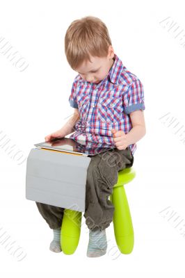 boy with a Tablet PC sitting on a chair