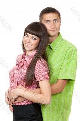 Beautiful couple in colored clothing. Studio portrait, isolate o